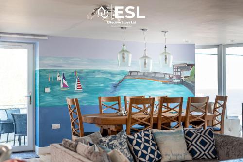a dining room with a painting on the wall at Beautiful En Suite 5 Bedroom Home with Sea Views in New Quay