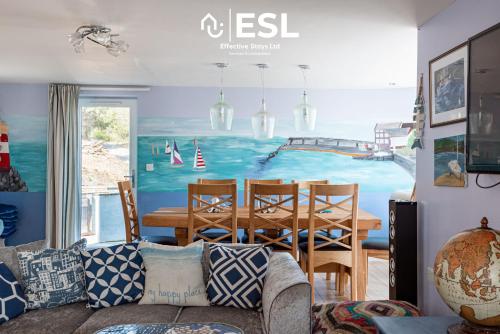 a living room with a couch and a dining room at Beautiful En Suite 5 Bedroom Home with Sea Views in New Quay