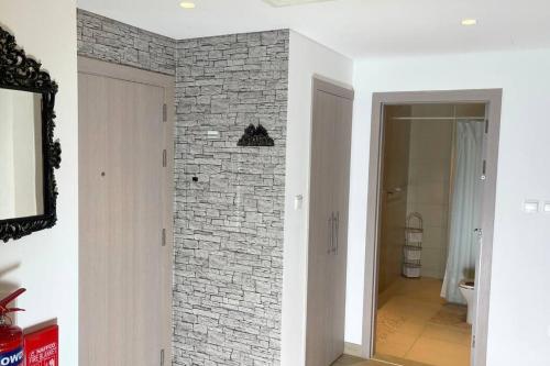 a room with a brick wall and a hallway at Cowboy Charm 1BR Apartment on Yas Island in Abu Dhabi