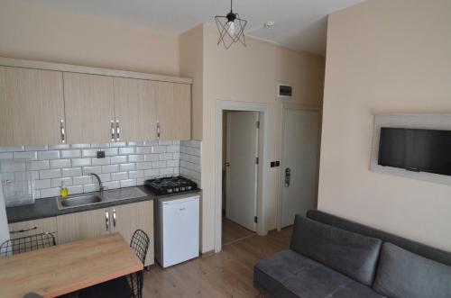 a kitchen and a living room with a couch at Arda Apart Hotel in Kemer