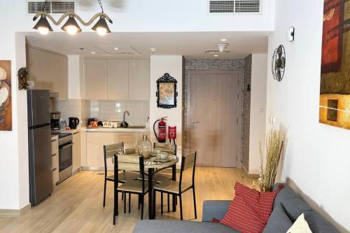 a kitchen and dining room with a table and chairs at Cowboy Charm 1BR Apartment on Yas Island in Abu Dhabi