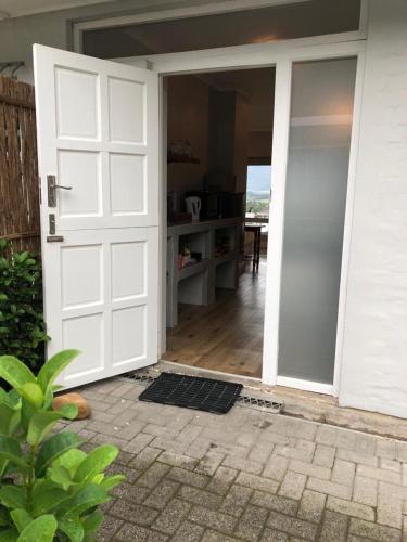 an open door of a house with a porch at Kortrijk Paarl Self Catering in Paarl