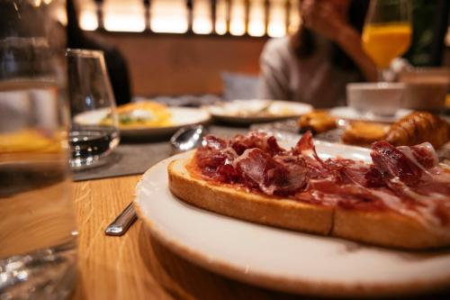 a plate with a pizza on a table at Bilder Boutique Hotel in Bilbao