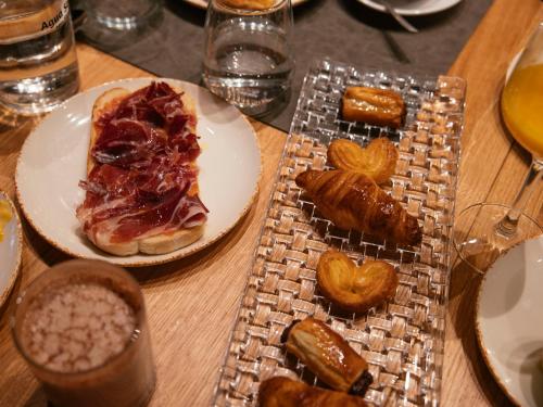 a table with a plate of food and a plate of pastries at Bilder Boutique Hotel in Bilbao
