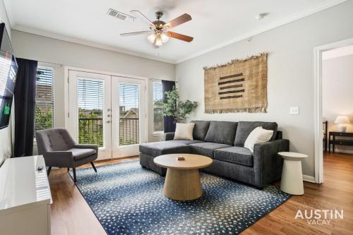 a living room with a couch and a table at Extremely Comfortable King Beds in Super Cute Apt in Austin
