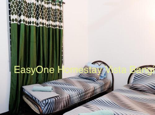 two twin beds sitting next to each other in a room at EZI homestay Vista Bangi in Kajang