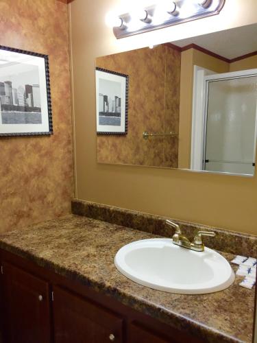 a bathroom with a sink and a mirror at Grand Inn in Big Lake