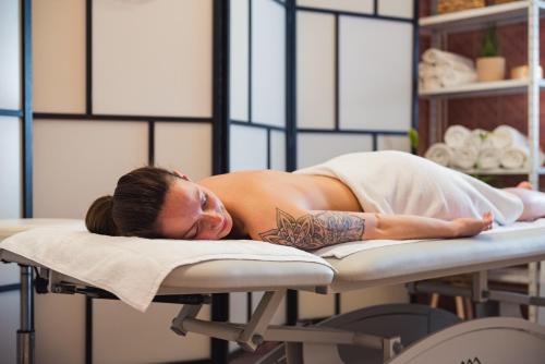 a woman laying on a table in a salon at HOTEL AGRI in Soběšice