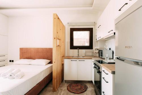 a small bedroom with a bed and a kitchen at Lux Studio near Center in Heraklio Town