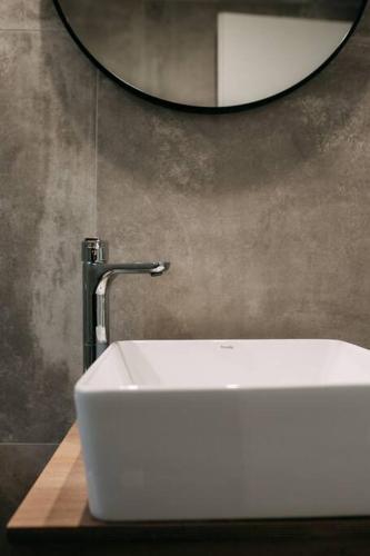 a white sink in a bathroom with a mirror at Lux Studio near Center in Heraklio Town
