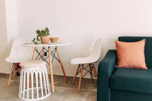 a living room with a table and a green couch at Lux Studio near Center in Heraklio Town