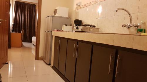 a kitchen with a sink and a counter top at Monalysa St Honore Apartment & Studios Grand Bay in Grand-Baie