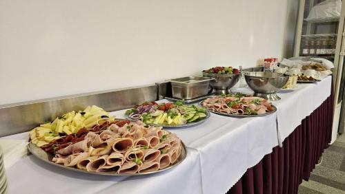 a buffet line with many plates of food on it at Black M - Penzión - Reštaurácia in Banská Štiavnica