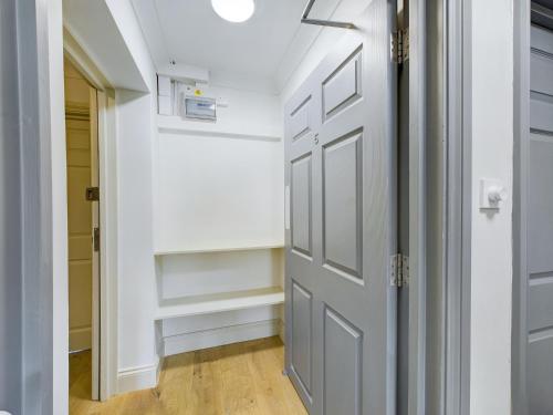 a hallway with a door and a closet at Duplex Redhill town centre Apt by Livingo Stays in Redhill