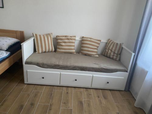 a white bed with pillows on it in a bedroom at R-Penzion in Český Krumlov