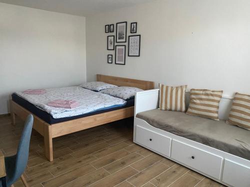 a bedroom with a bed and a couch at R-Penzion in Český Krumlov