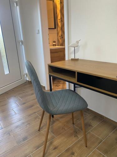 a chair sitting in front of a wooden desk at R-Penzion in Český Krumlov