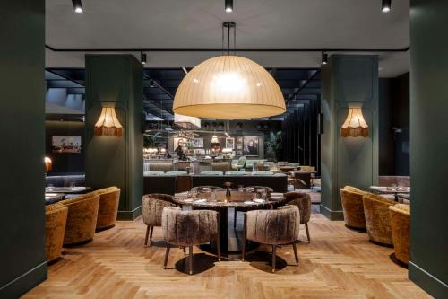 a dining room with a table and chairs at Radisson Collection Hotel, Santa Sofia Milan in Milan
