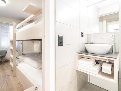 a bathroom with a bunk bed with a sink and a sink at Traube Restaurant & Hotel in Appenzell