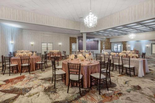 a banquet hall with tables and chairs in a room at Wyndham Garden York in York