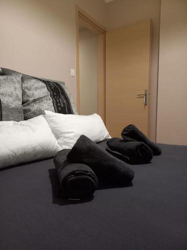 a bed with two pillows on top of it at Kassandrou Deluxe Apartment in Thessaloniki
