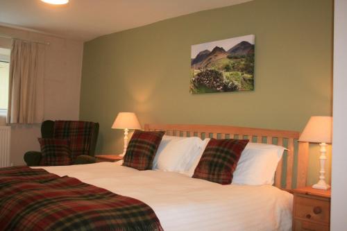 a hotel room with a bed and two chairs at StoneyAcre in Keswick