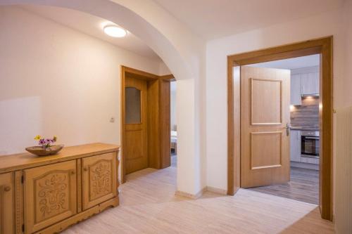 a room with a hallway with a door and a kitchen at Bauernhof Nagelschmiedhof in Langkampfen