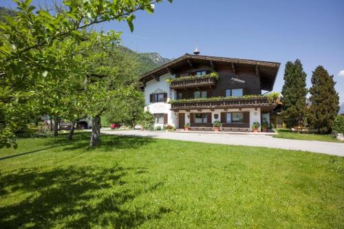 a house with a green lawn in front of it at Bauernhof Nagelschmiedhof in Langkampfen