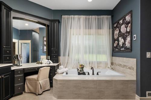 a bathroom with a large bath tub with a window at Punkin Manor in Newberg