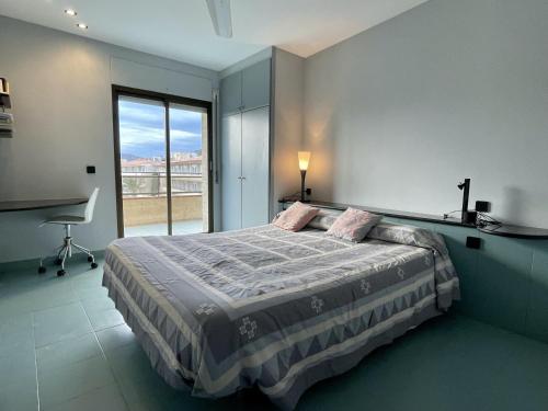 a bedroom with a bed and a large window at La Pineda I 1 3-6 in L'Estartit