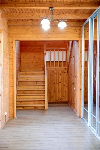 a large room with wooden walls and a large door at Villa SeaZone in Zatoka