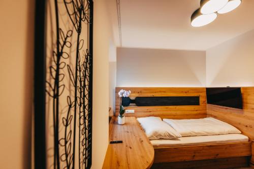 a bedroom with a wooden bed and a wooden table at Allhartsberger Hof in Allhartsberg