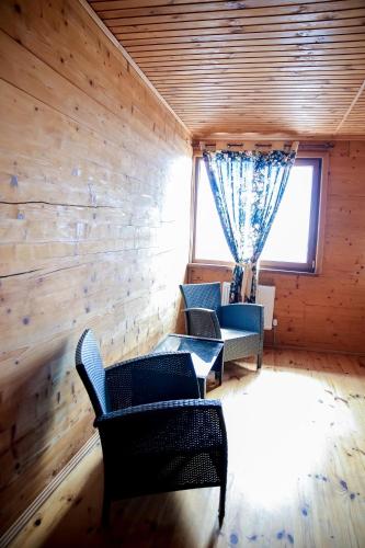 a living room with two chairs and a window at Villa SeaZone in Zatoka