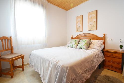 En eller flere senge i et værelse på Casita adosada de playa en Porto Meloxo - Grove