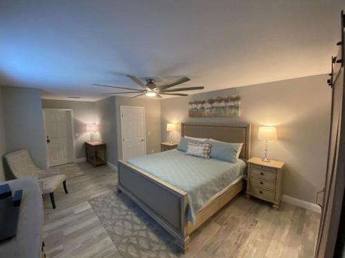 a bedroom with a bed and a ceiling fan at 3 bedroom 2 bath with hot tub, game room and boat slip in Crystal River