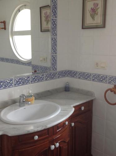 a bathroom with a sink and a mirror at Dúplex con vistas a la ría de Mogro by Alterhome in Mogro