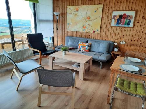 a living room with a couch and a table and chairs at Ferienwohnungen Ute am Geyersberg inkl AktivCard Bayrischer Wald in Freyung