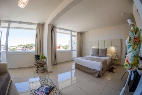 a hotel room with a bed and a couch at ON Hotels Oceanfront Adults Designed in Matalascañas