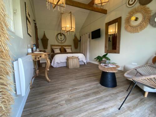 a large room with a bed and a table at Entre Honfleur et Etretat in Octeville-sur-Mer