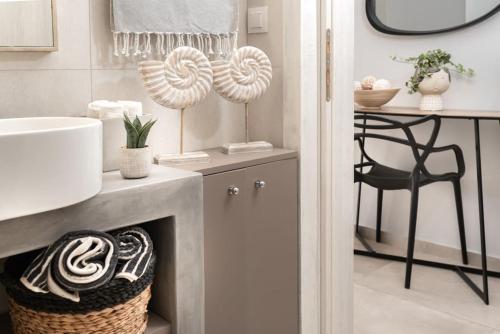 a bathroom with a fireplace and a sink and a chair at Helios in Ierápetra