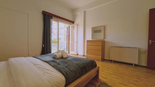 a bedroom with a large bed and a window at STAY Mythos Down Town House in Nicosia