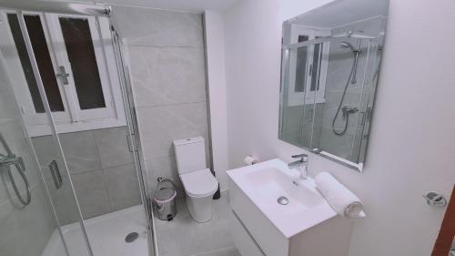 a white bathroom with a shower and a sink at STAY Mythos Down Town House in Nicosia