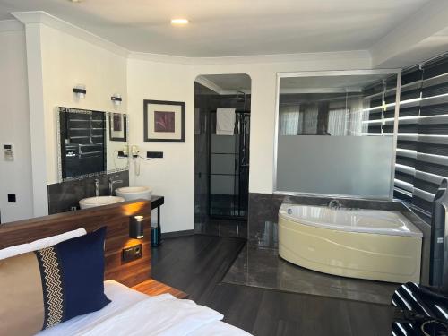 a large bathroom with a tub and a sink at Seven Dreams Hotel in Istanbul