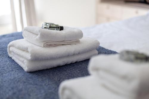 a pile of towels sitting on top of a bathroom counter at Bright Studio Flat in the Heart of Marylebone in London