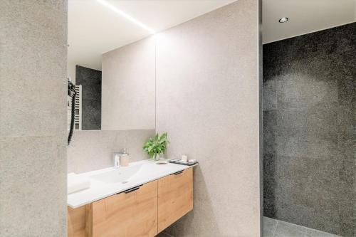 a bathroom with a sink and a mirror at Hotel und Therme NOVA in Köflach