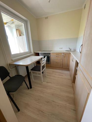 a small kitchen with a table and a window at Ruses. One Bedroom Apartment in Rīga