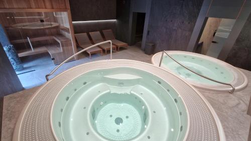 a bath tub with a teddy bear inside of it at Wielka Krokiew Residence&SPA - Zakopane - JACUZZI, SAUNA, TĘŻNIA SOLANKOWA, SPA, GRILL in Zakopane