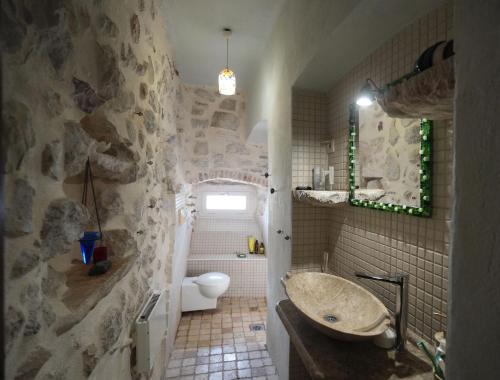 a stone bathroom with a sink and a toilet at Apartment Dyonis Perast in Perast