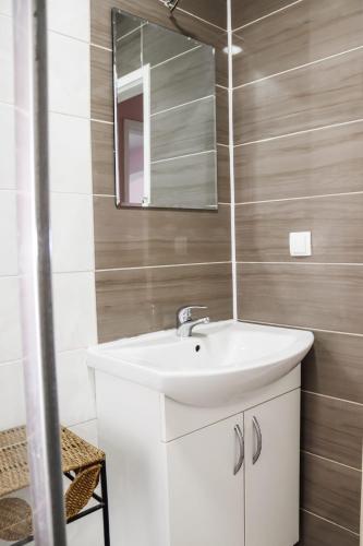 a bathroom with a white sink and a mirror at Sunny House in Čapljina