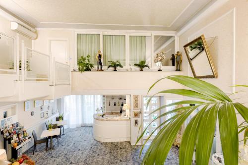 a living room with a staircase and a person standing on a shelf at HOTEL Villa Lilla in Desenzano del Garda